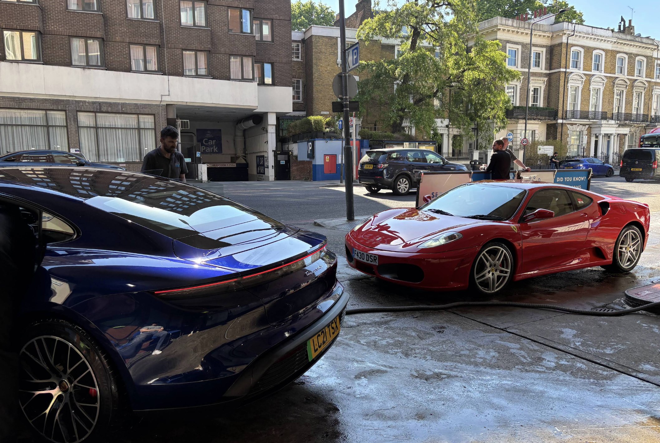 Aston Martin and Ferrari: queued on Holland Road at Kensington's Car Wash